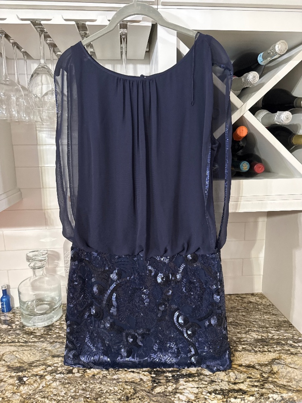 Short blue sequined dress.